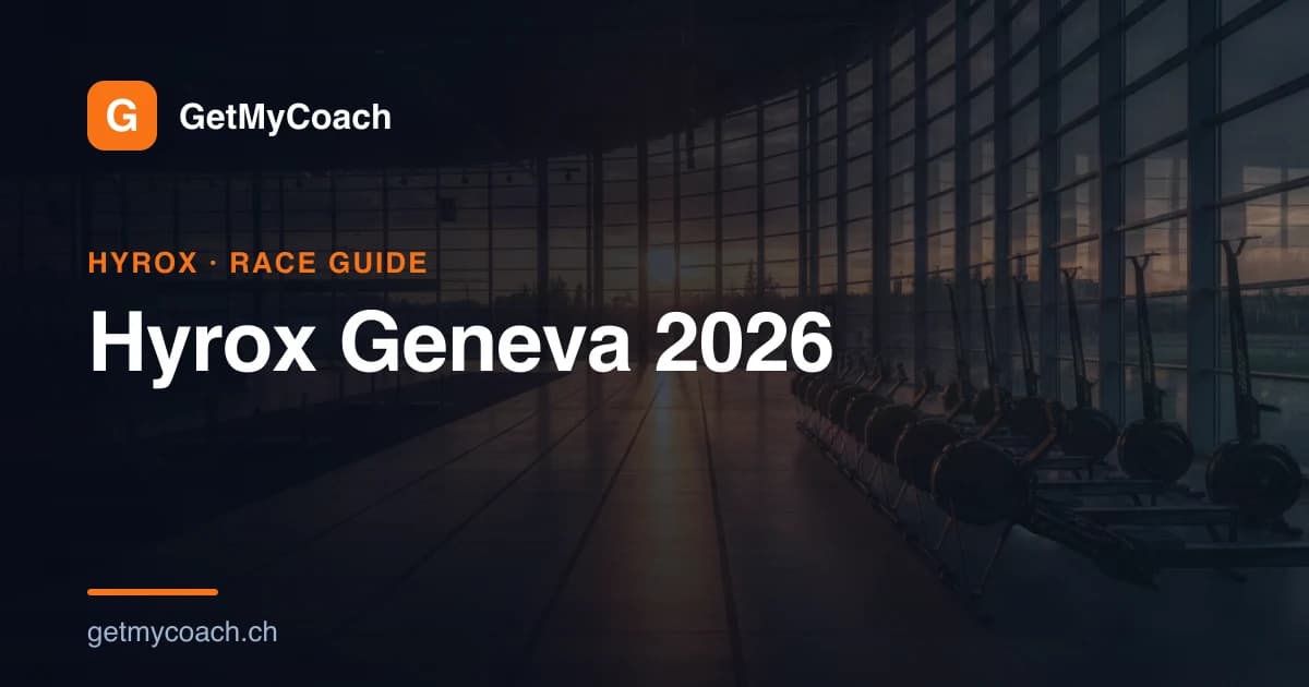 A wide indoor exhibition hall laid out for a fitness race at dusk, lanes marked on the floor and light rigs overhead — cover image for the GetMyCoach race-day guide to Hyrox Geneva 2026 at Palexpo.