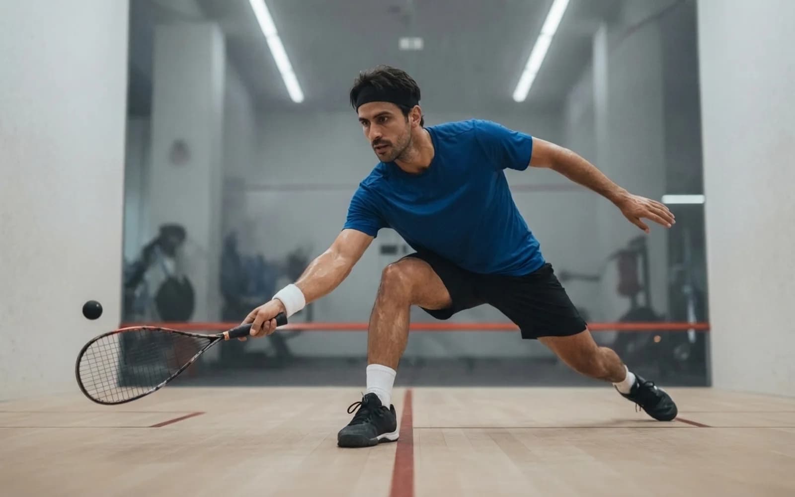 Squash Performance Coach lunging into a forehand on a squash court