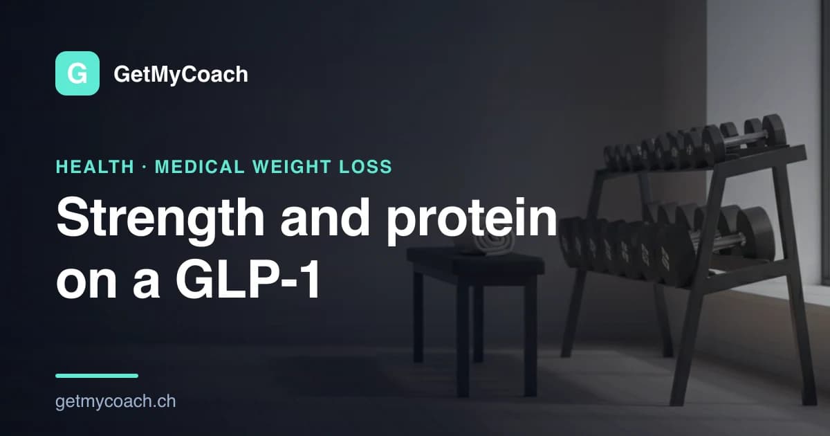 A rack of dumbbells and a flat bench on the pale wooden floor of a quiet, empty gym in soft daylight — cover image for the GetMyCoach guide to strength training and protein during GLP-1 weight loss.