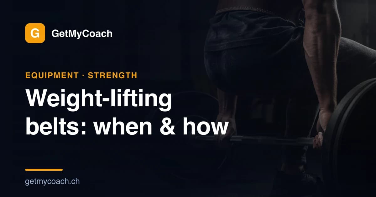 A leather weight-lifting belt cinched around a lifter's waist over a loaded barbell in a moody strength gym.